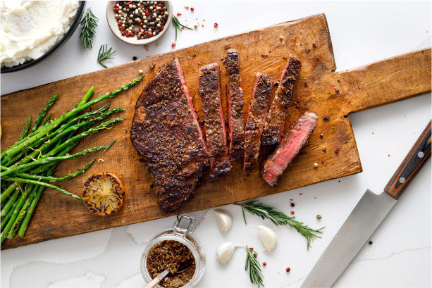 ribeye steak on cutting board