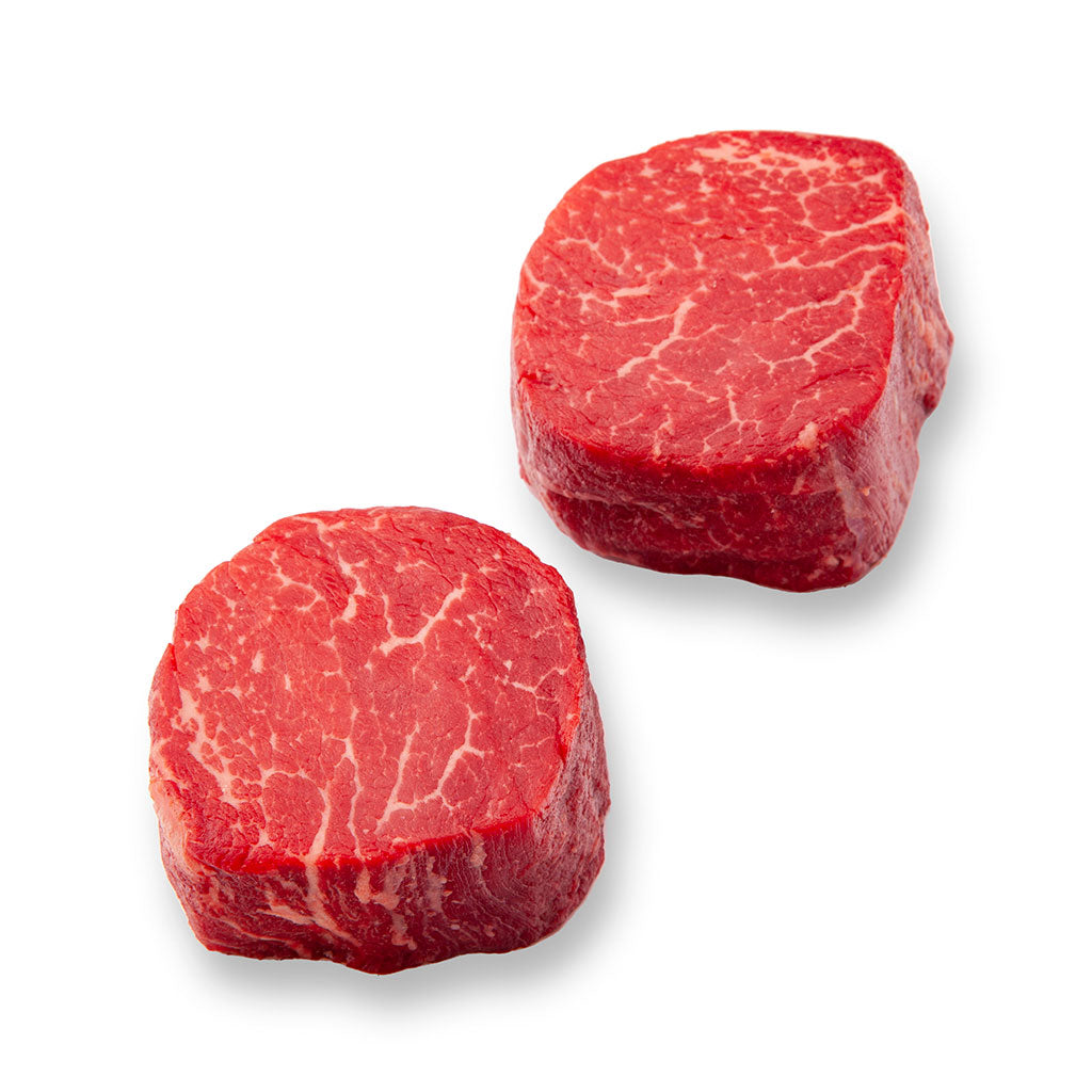 two raw tenderloin steaks